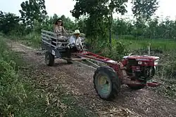 Kubota two-wheel tractor pulling a cart.