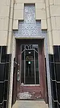 Entryway with art deco ornamentation and "KYLE" over the door