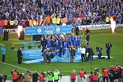 Picture of Leicester City players lifting the Premier League Trophy
