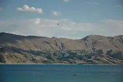 Color photograph of a lake with gorges leading into it