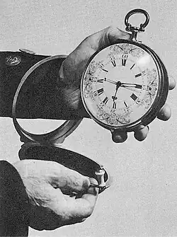 A large pocket watch, about 13 centimetres in diameter