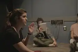 Shippen sat in a room with at least two other people