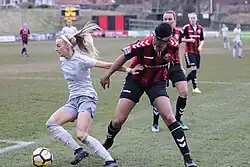 Kelly (left) pushes off a Lewes FC defender, 2018