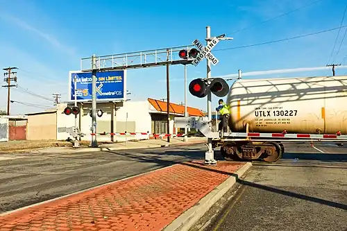 Because there is no caboose, the employee must stand on the last car of this Union Pacific train going in reverse, to make sure the track is clear; something the ETD cannot currently do.