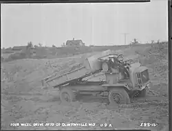 Luella Bates unloading sand from a FWD Model B truck.