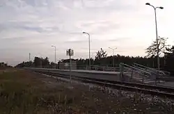 Simple railway stop with no buildings or notable facilities beyond a platform with a small shelter
