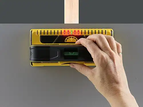 A yellow stud finder with a row of LEDs.