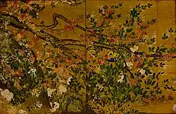 Part of a tree with leaves, red blossoms and white blossoms.