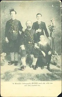 The photograph's inscription reads in Greek: "Macedonian warlord Kotes with his sons and a supporter."