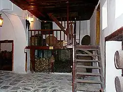 Entryway, with stone floor and wooden stairs