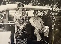 Madame Elizabeth Shoumatoff with President Roosevelt, seated in vehicle.