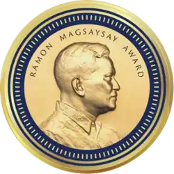 Medallion with an embossed image of Ramon Magsaysayl facing right in profile.