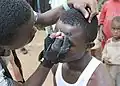 Makeup artist preparing an Atilogu dancer - Igbo Tribe - Oji River - Enugu State - Nigeria Rivulet of the Oji river flowing through the Inyi community, Identified as a class one rapid with tree covering.