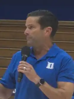 Headshot of Diaz with a microphone inside a stadium