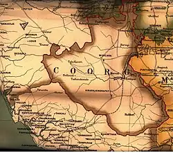 The map shows sparsely labelled Coorg. The Arabian Sea is shown on the left