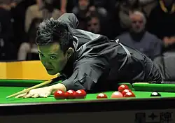 Marco Fu playing a shot