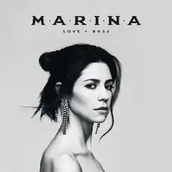 A greyscale photograph of Marina facing sideways, while gazing into the camera. Above her, the album's title and her name are placed in black lettering.