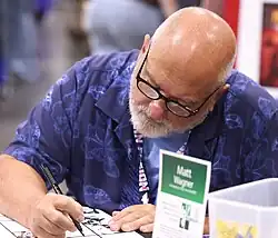 Wagner seated at a table