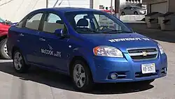 Small car with "Newsboy IV" on the hood