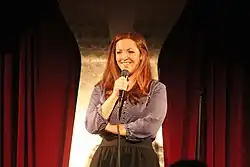 Gailey holding a microphone onstage