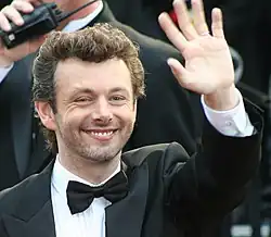 Close-up of Sheen outdoors, smiling and waving