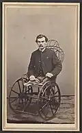 Amputee in a 19th-century wheelchair