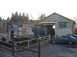 Stone building with steam railway engine outside it.
