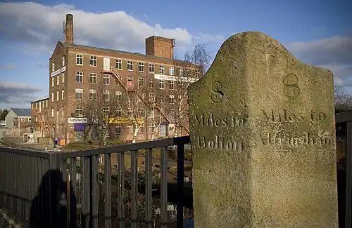 A milestone on Patricroft Bridge, along the Barton and Moses Gate turnpike road, near Eccles. Note the older spelling of 'Altringham' - latterly Altrincham.