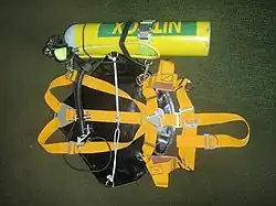Minimalist sidemount harness showing webbing, sliders and D-rings, buoyancy compensator, integrated weight holders and cylinder