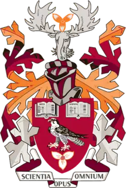 Coat of Arms of Mohawk College with primarily burgundy, crimson, and orange colours