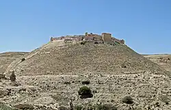 A ruined castle built of stones on a hill