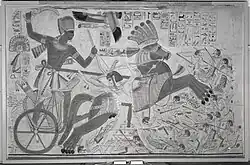 Mural of Seti I holding a khopesh while riding in a war chariot and trampling Libyans found at Karnak.