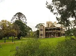 This is a photograph of the heritage-listed Murray House and surrounding parklands on the Magill campus.