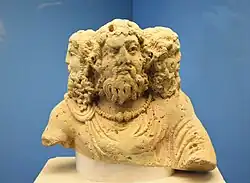 Three-headed bust of Cernunnos from Condat-sur-Trincou, Dordogne. The central head wears a torc and has holes for antlers.: no 9 