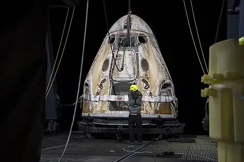 Crew Dragon Endeavour is lifted onto MV GO Navigator after splashdown