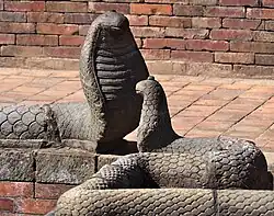 Snake sculptures on the rim