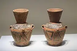 Two painted red jars