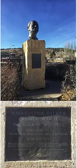 Navajo Code Talker is a Bronze bust sculpture created by famed Navajo Artist R.C. Gorman. Gorman used his father, Carl's likeness for this sculpture. Carl was a Navajo Code Talker in WWII. The face is that of an elderly Navajo man looking up and our in a proud manner. It sits on an 8ft marble base on the NAU campus in Flagstaff Arizona. Bright blue skies surround the bust with the mountains visible in the distance.