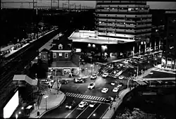 Black and white photo of train station at nightfall.