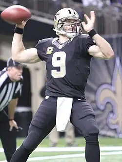 Drew Brees on the field in a throwing motion