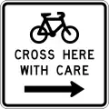 Cyclists Cross Here With Care (to the right)