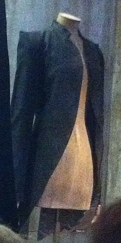 An open black jacket with nothing underneath, on a mannequin