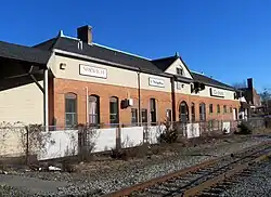 A reused railway station next to a single track