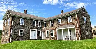 A large L-shaped stone house