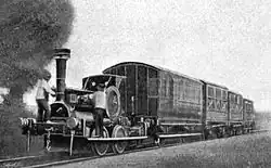 Small locomotive hauls four coaches of various designs