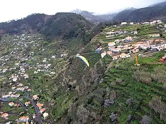 A paraglider over the locality of Achada de Santo Antão