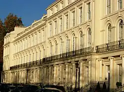 Long, three-story, light-coloured building