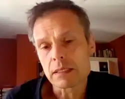 close-up of Pekka Johannes Hämäläinen appearing to speak to a webcam, looking downward and to the right