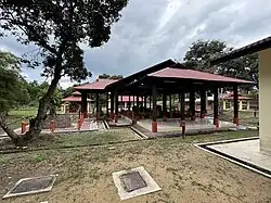 A collection of small shelters holding various large rocks or structures