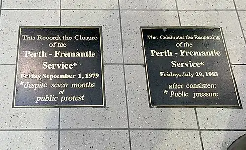 Two plaques on a tiled floor